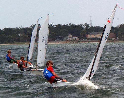 Three young Optimist Dinghy sailors slog to windward in last summer’s US Sailing Junior Olympics Sailing Festival hosted by Pensacola Yacht Club. © Talbot Wilson